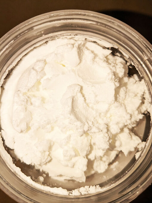 Sodium Methyl Cocoyl Taurate paste - a white paste in a clear container.